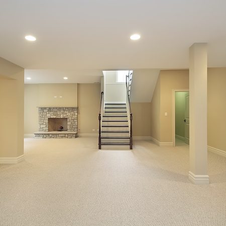 Basement in new construction home with stone fireplace