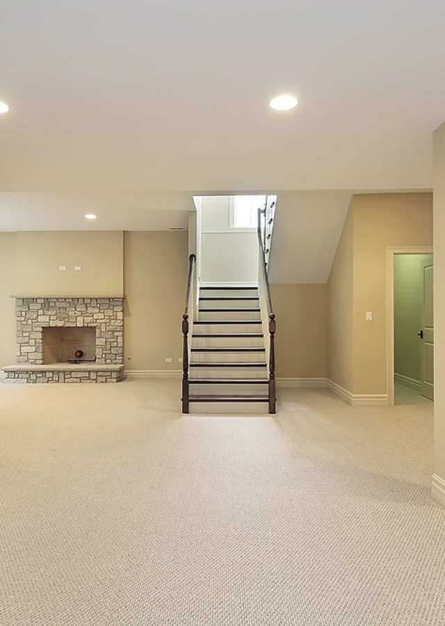 Basement in new construction home with stone fireplace